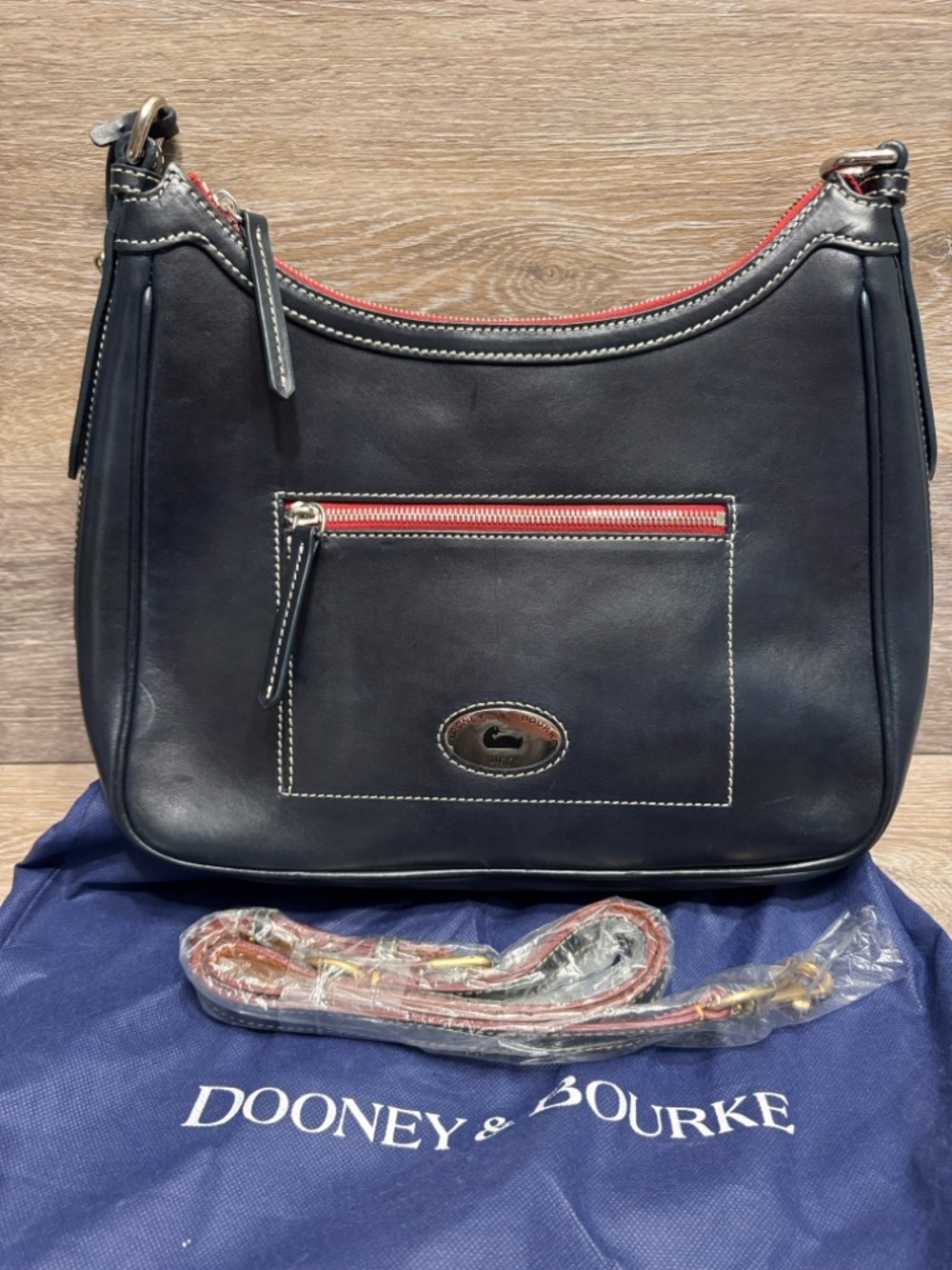Dooney & Bourke signature hobo style. Smooth leather exterior Toscana Crossbody